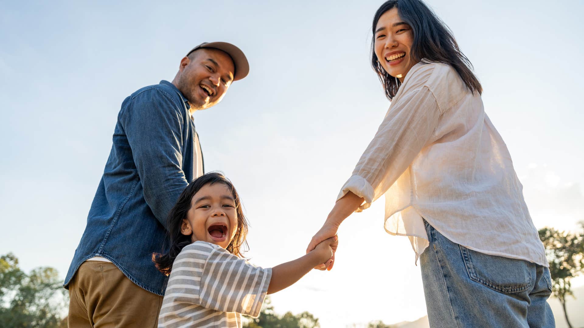 tough parents holding hands with happy daughter who bounces back from setbacks