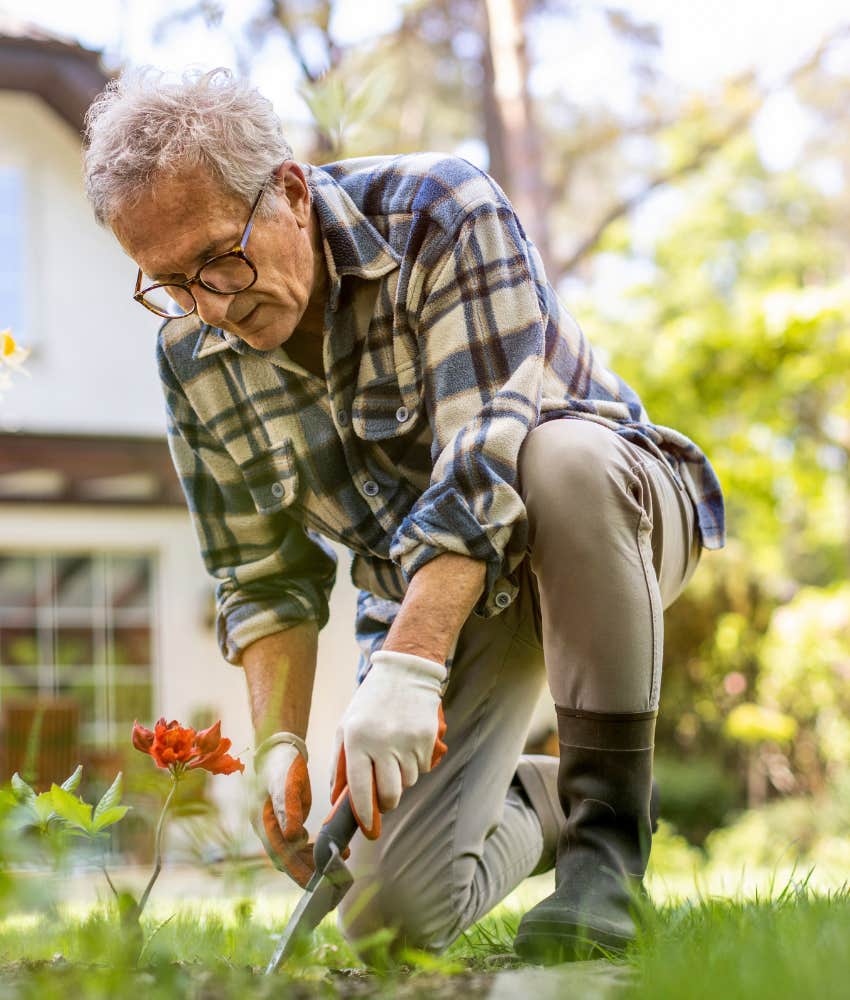 Retired man doing handyman stuff in the yard for his kids