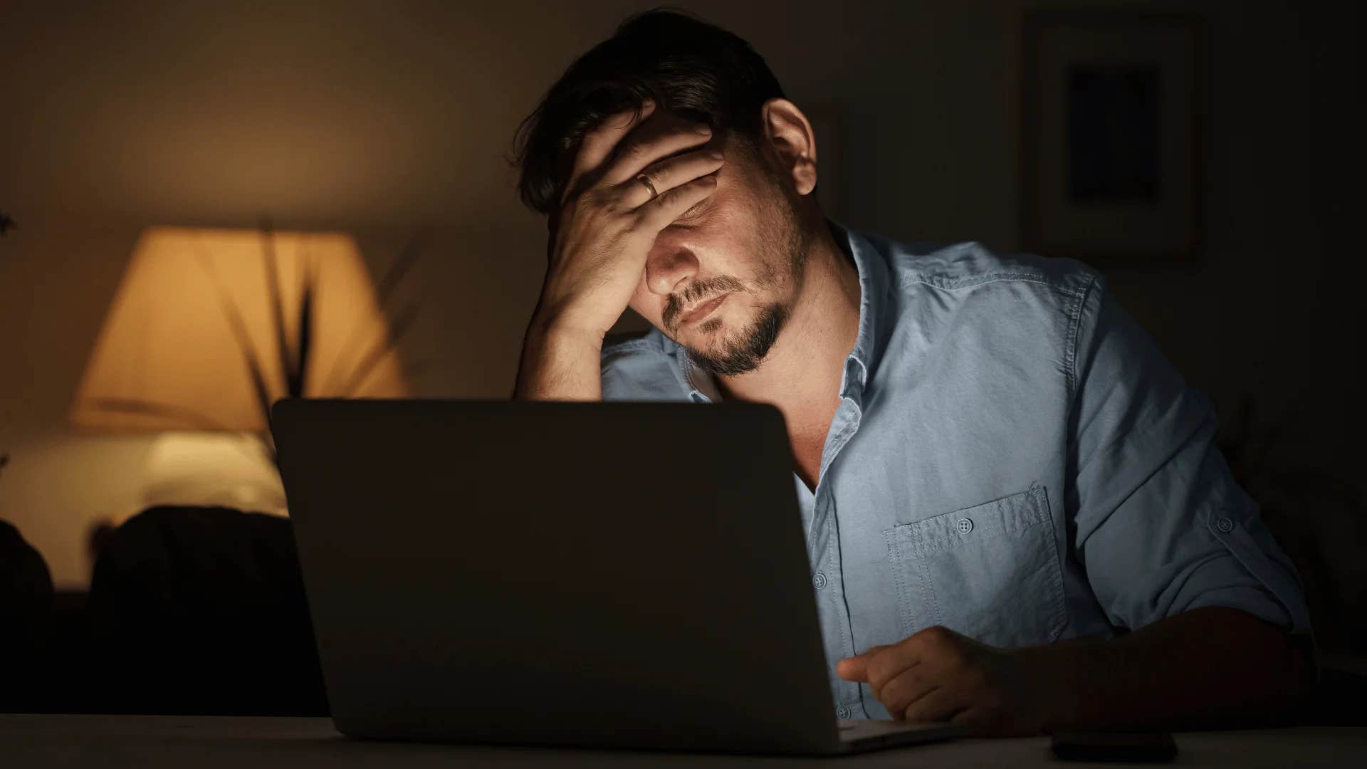 man working late dreading going to the office in the morning
