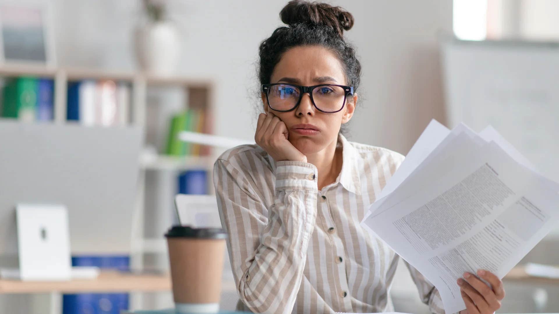 stressed woman procrastinating on work projects