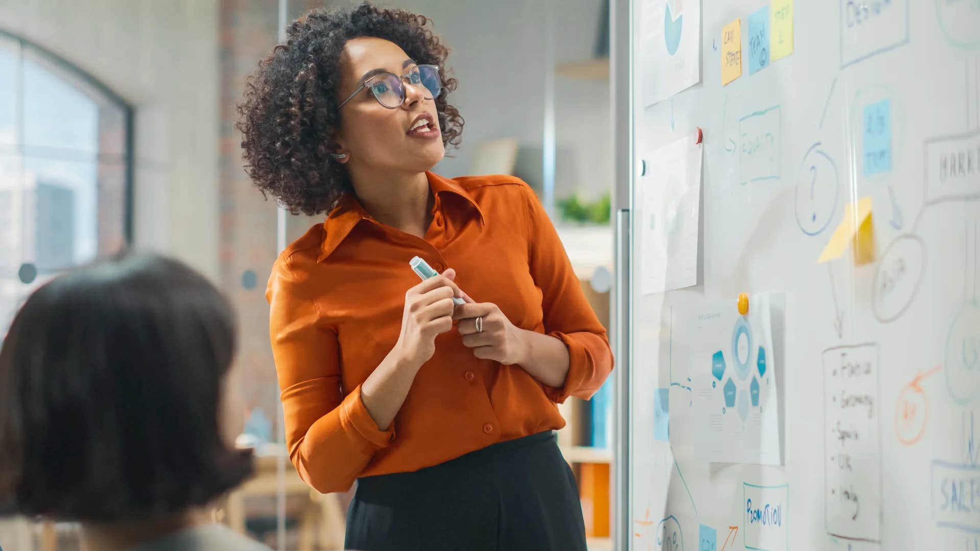 woman who hasnt gotten a raise giving a presentation at work