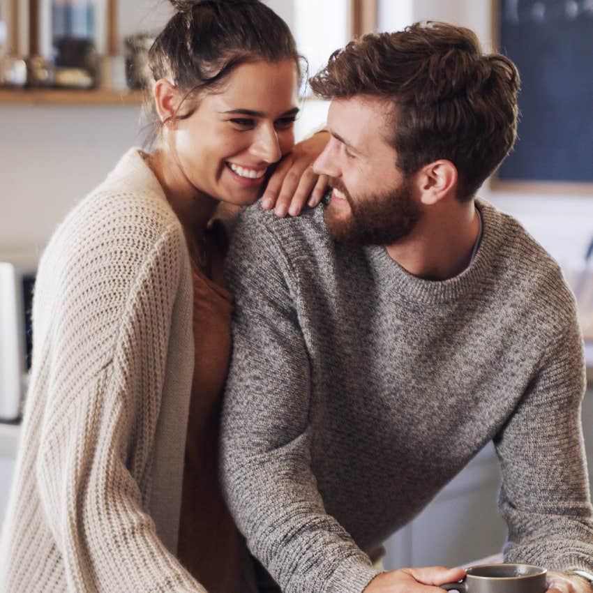 unusually happy couple talking in the kitchen connecting over emotional intimacy 