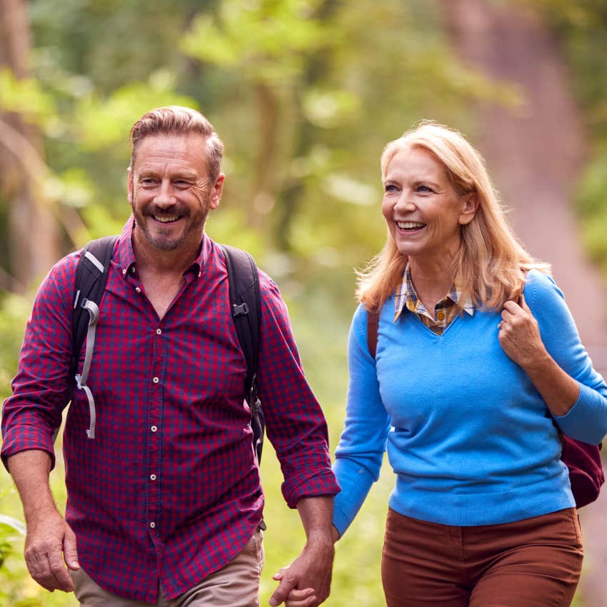 unusually happy couple walking in the woods connecting over recreational intimacy 