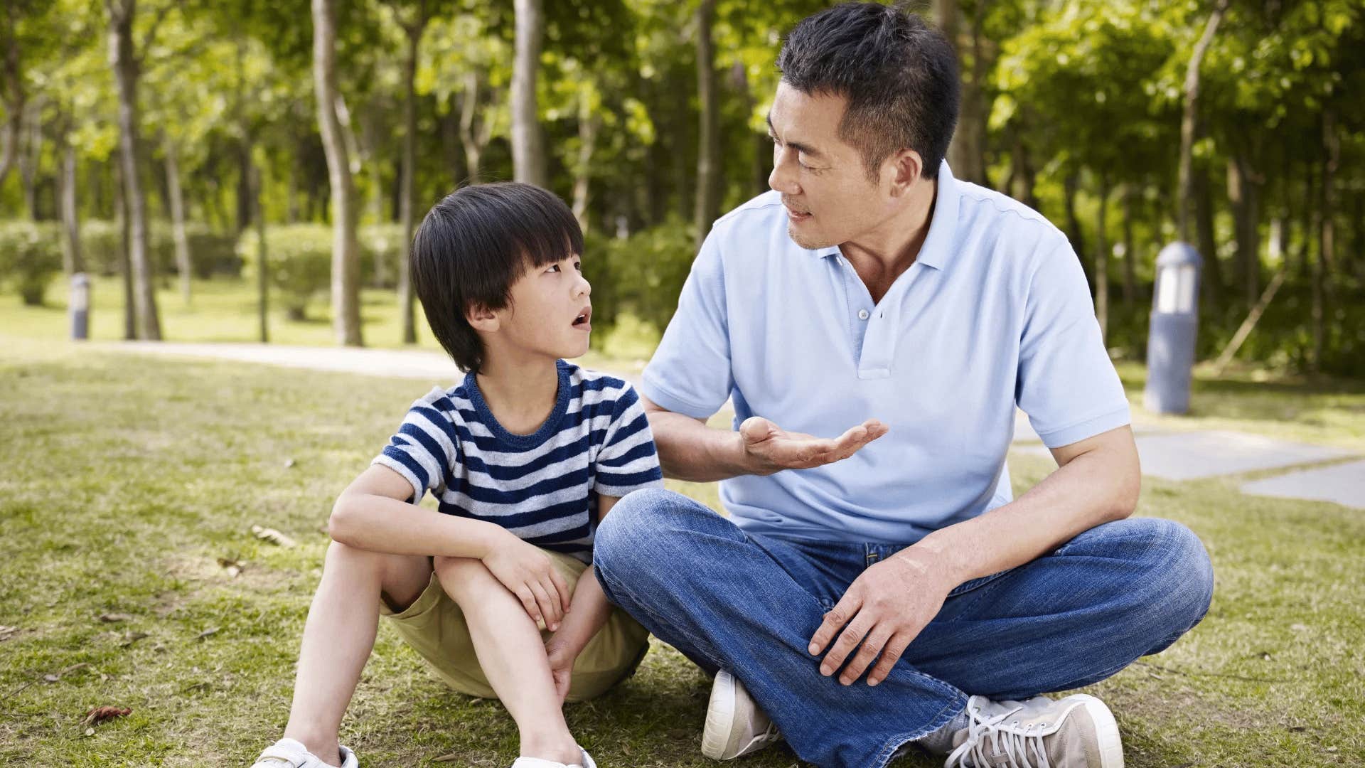 gen Z dad having a talk with his son outside