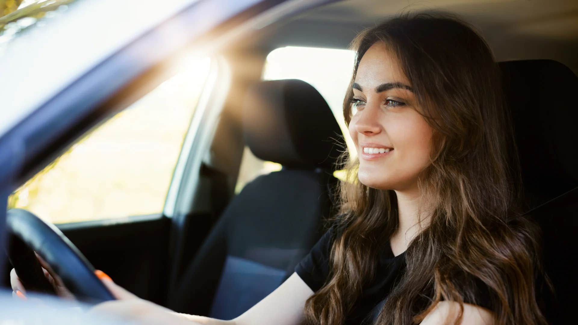 gen Z woman driving a car looking a bit anxious