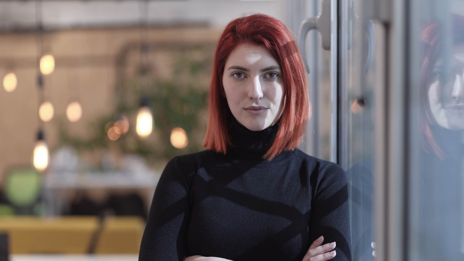 insecure woman wearing black turtleneck hoping no one looks at her