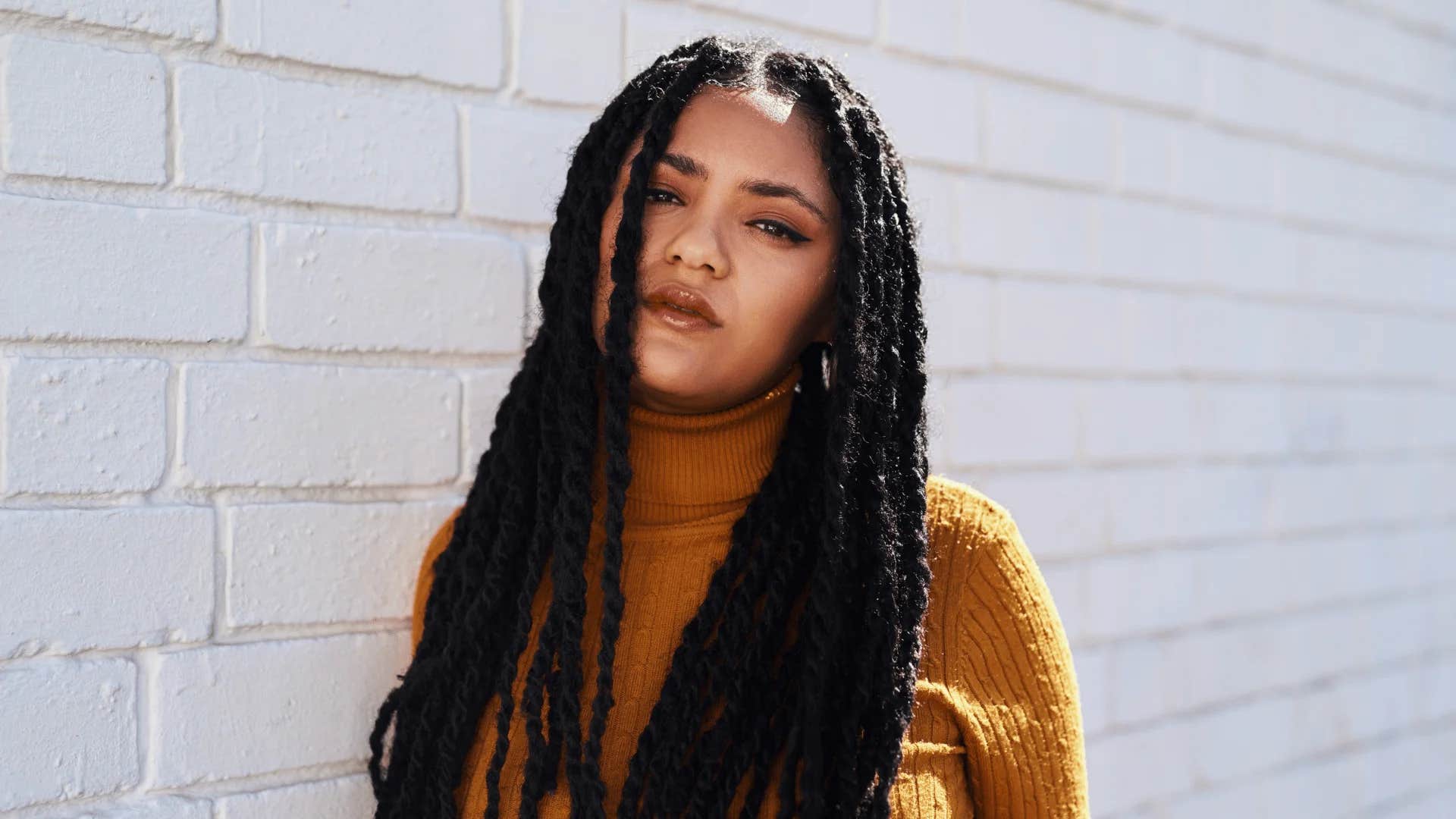 insecure woman wearing large sweater that hides her imperfections