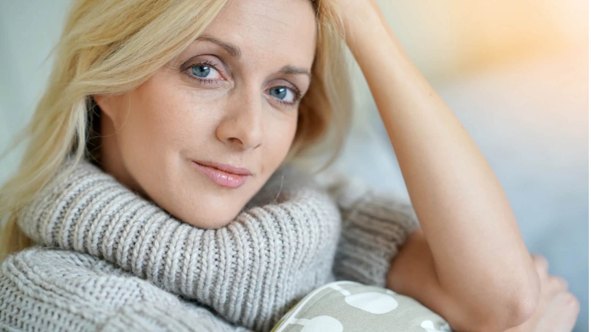 insecure woman wearing modest sweater hoping no one looks at her