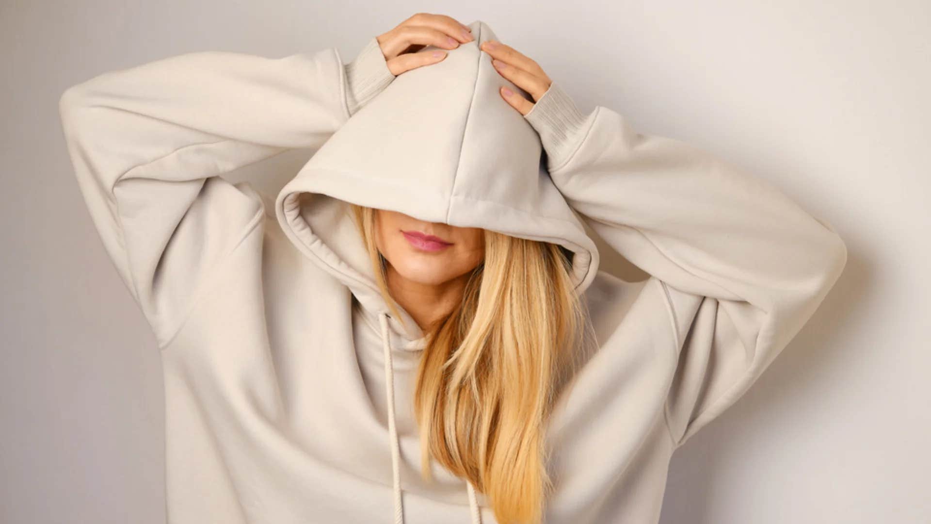 insecure woman wearing oversized sweatshirt so no one looks at her
