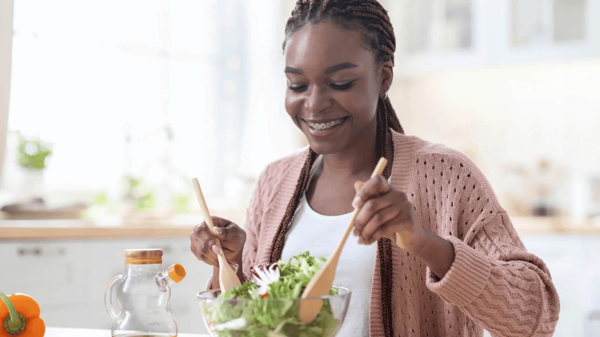 woman making a salad saving money by making her own dressing