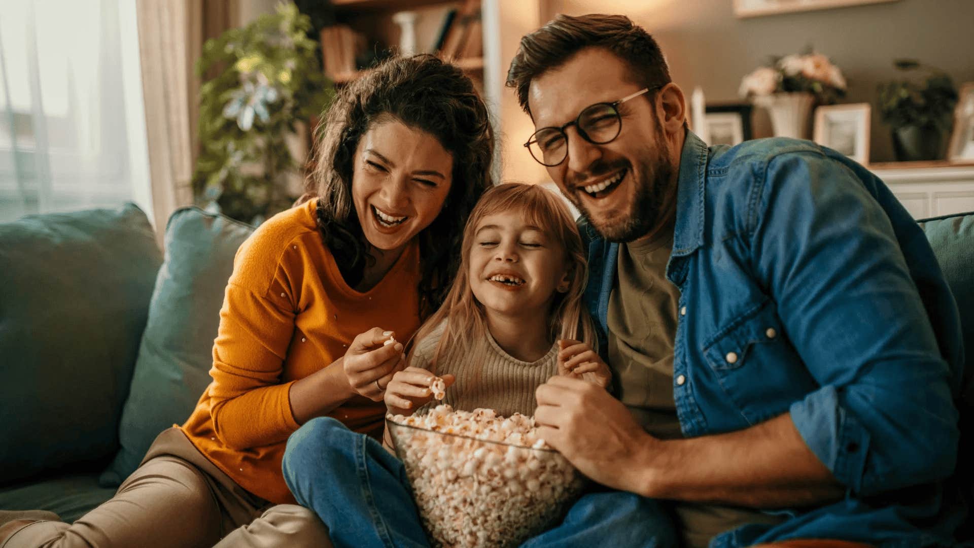 family watching movie together with popcorn
