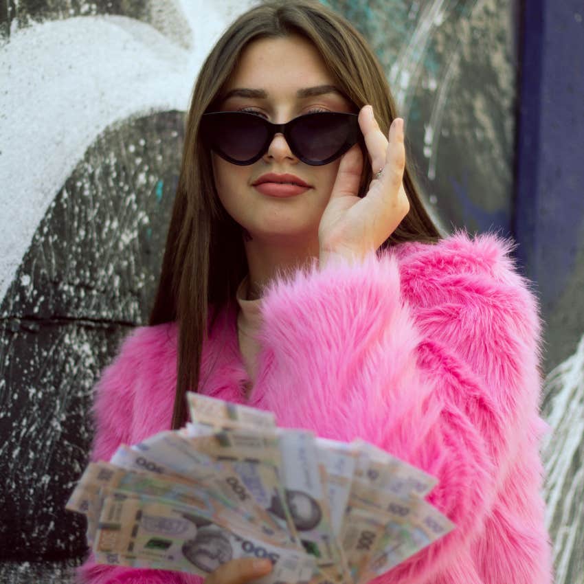 gen Z woman smiling spending money instead of saving it