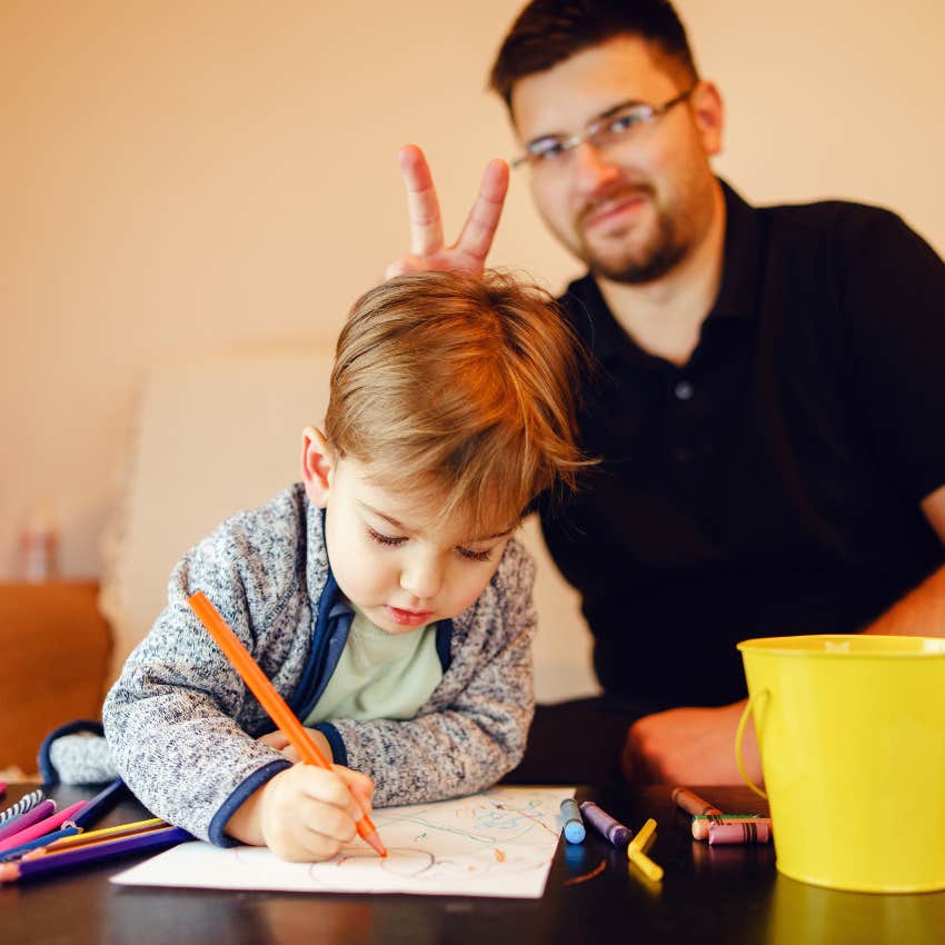 silly uncle who refuses to reinforce lessons in manners with nephew doing bunny ears behind his back