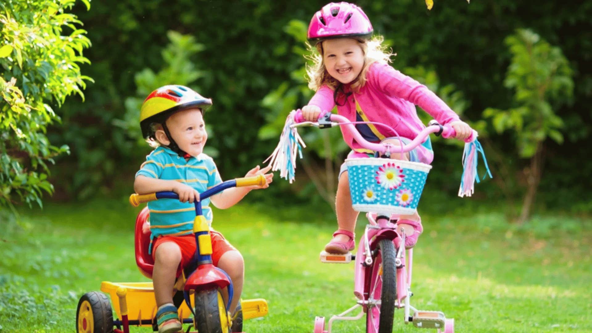 little girl and her young brother riding bikes together