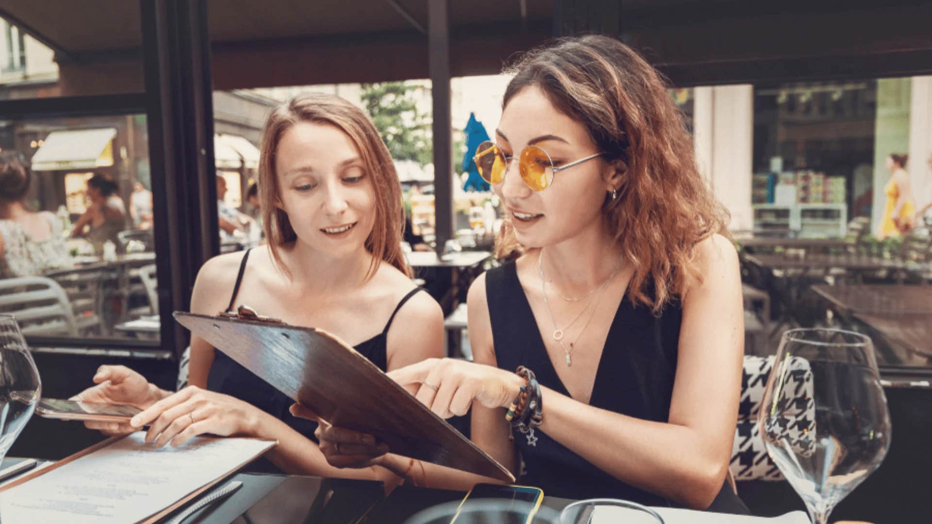 two friends looking at restaurant menu