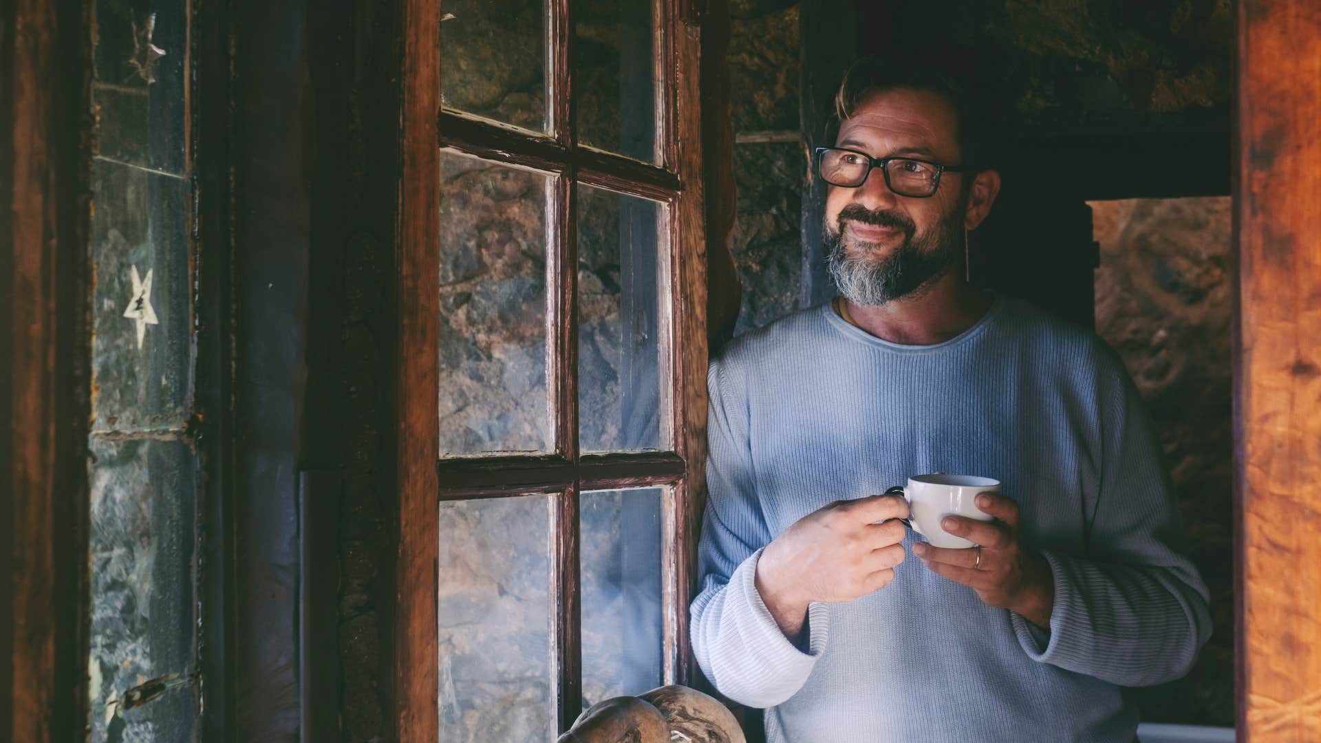 mentally strong man looking out window silencing his fears