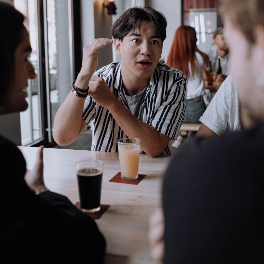 intelligent man explaining a concept in simple terms for his friends