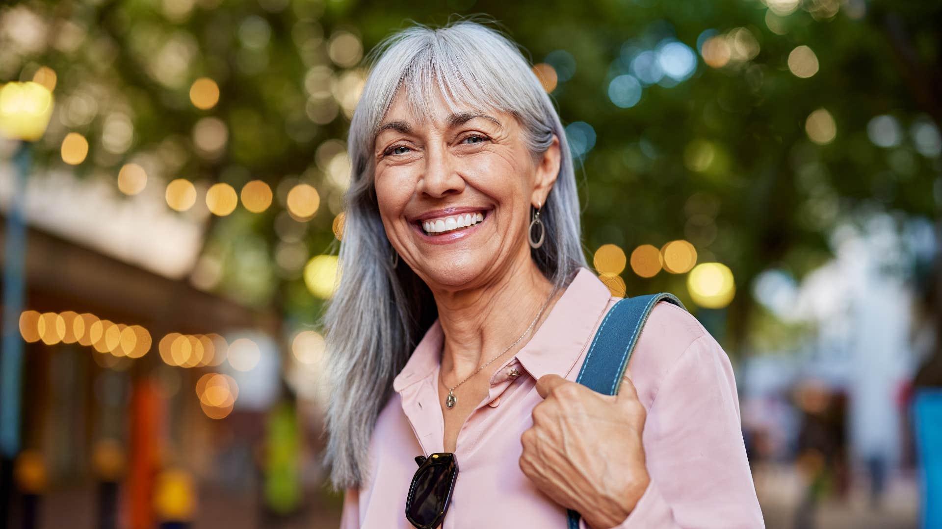 mature woman with mental and emotional integrity smiling and unbothered by gossip