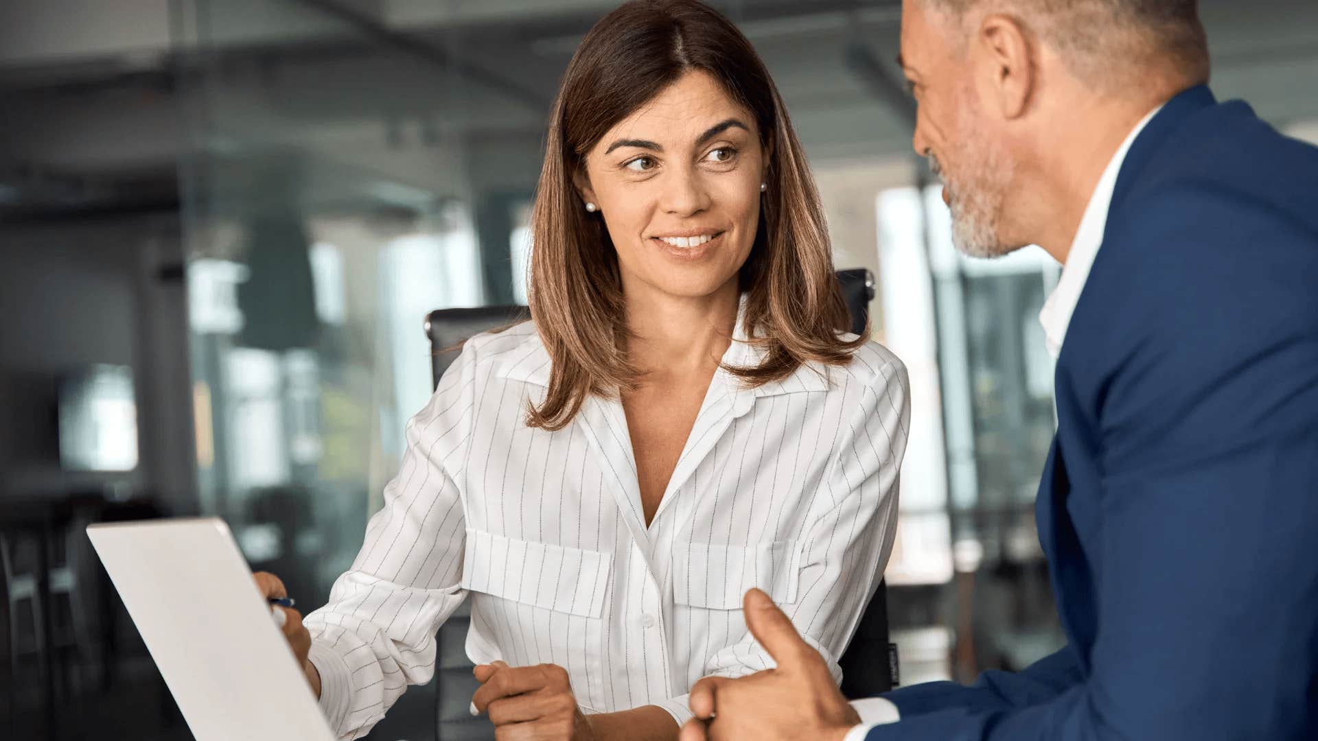 happy woman at work focusing on her personal growth with colleague