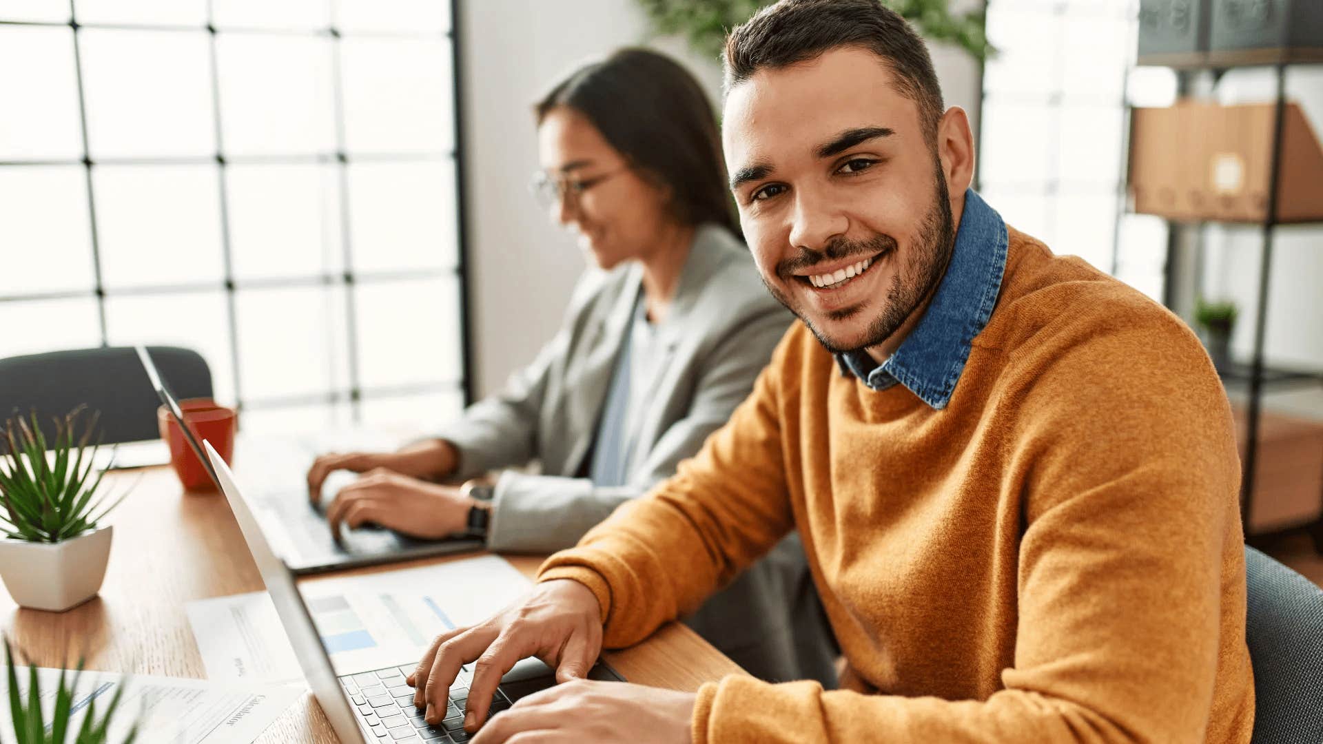 man smiling thinking about all the people he helps at work