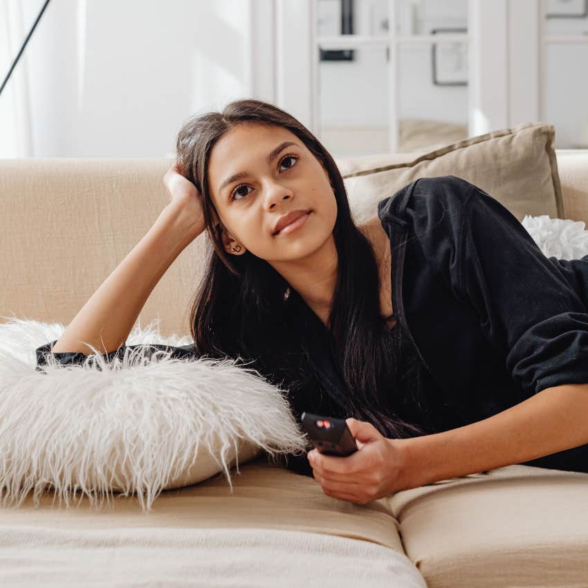 woman with a lot of time on her hands watching tv mindlessly
