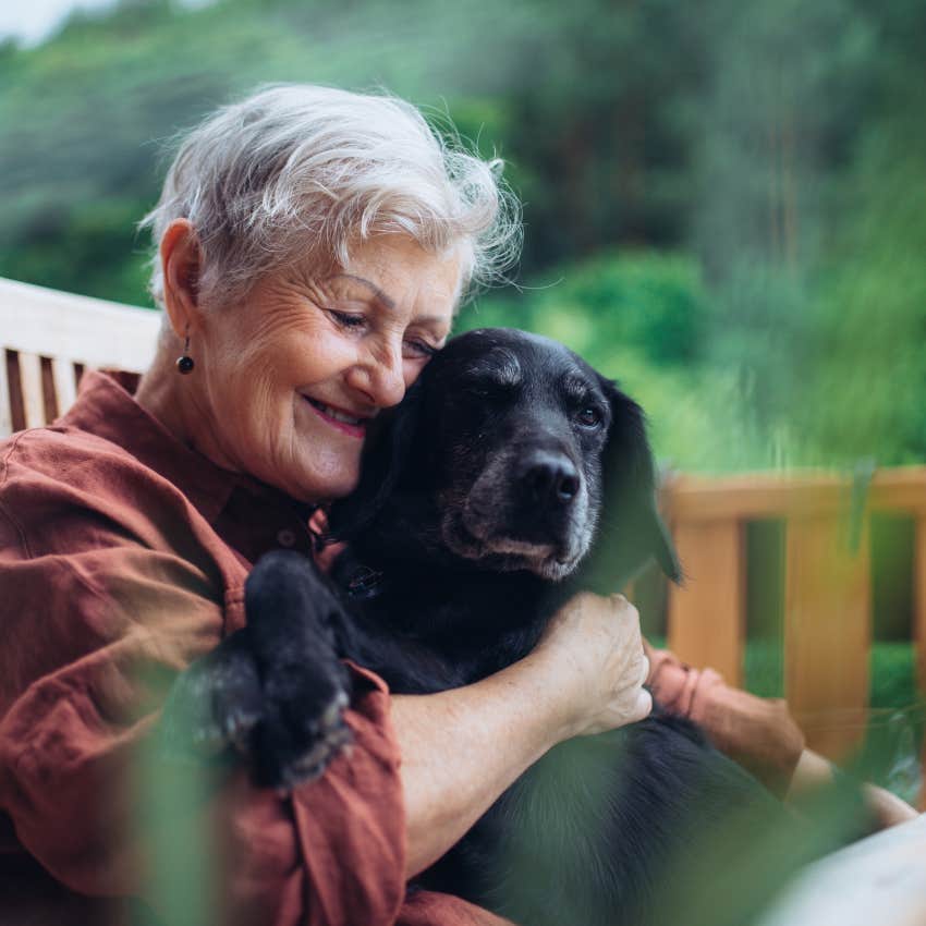 mature woman hugging dog regrets waiting for permission to be happy in her 40s