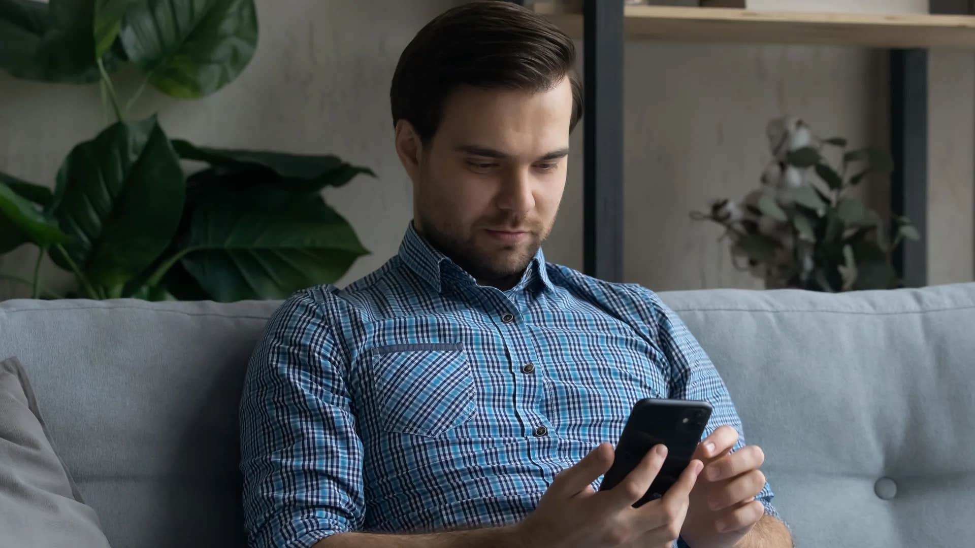 man looking at his phone thinking about memories with ex
