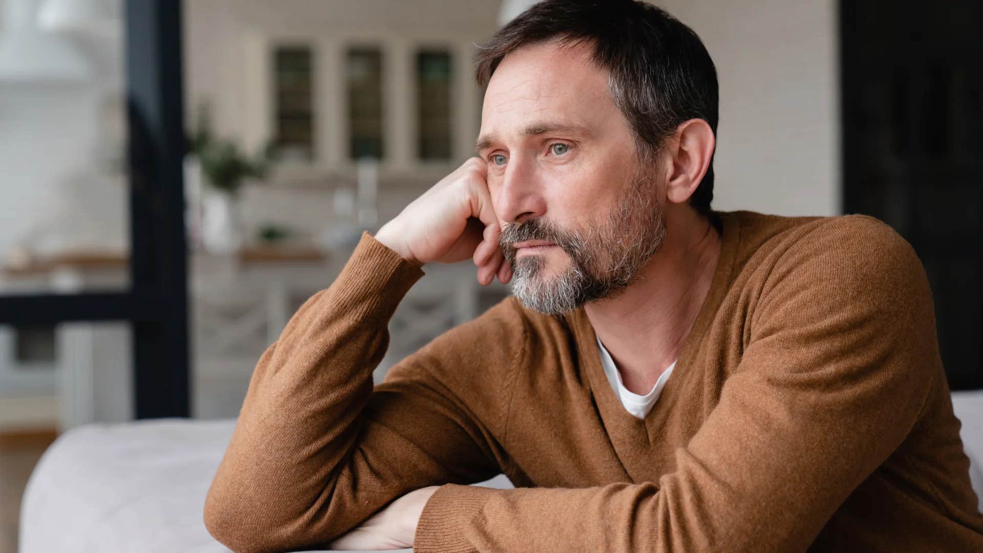 man deep in thought after ending a relationship