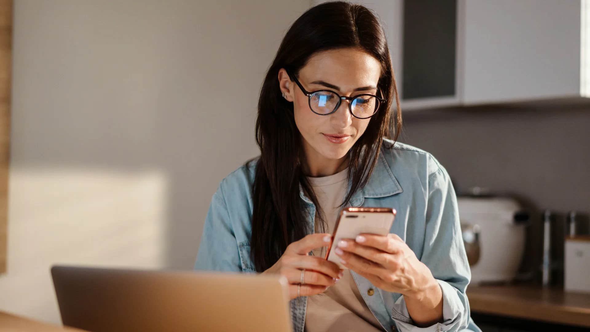 woman looking at her phone not texting her ex