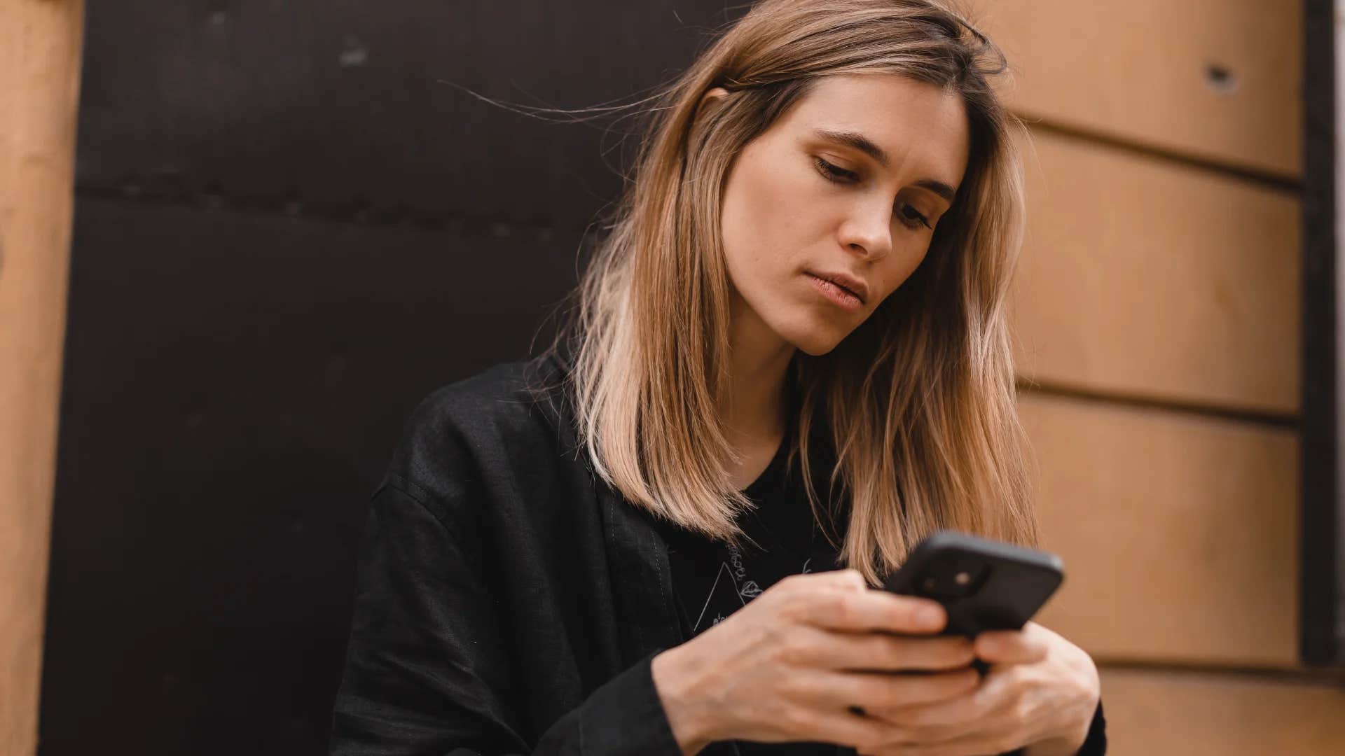 woman quietly unfollowing her ex on social media