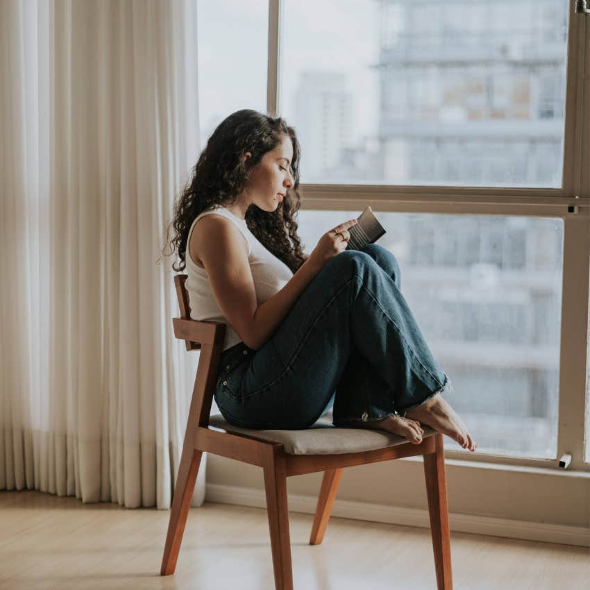 Thoughtful adult woman relaxing at home while trying to let go of her usual responsibilities and enjoy herself