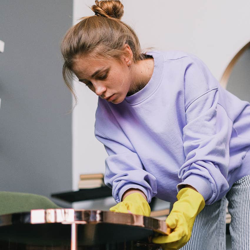 unhappy woman doing housework without husband helping