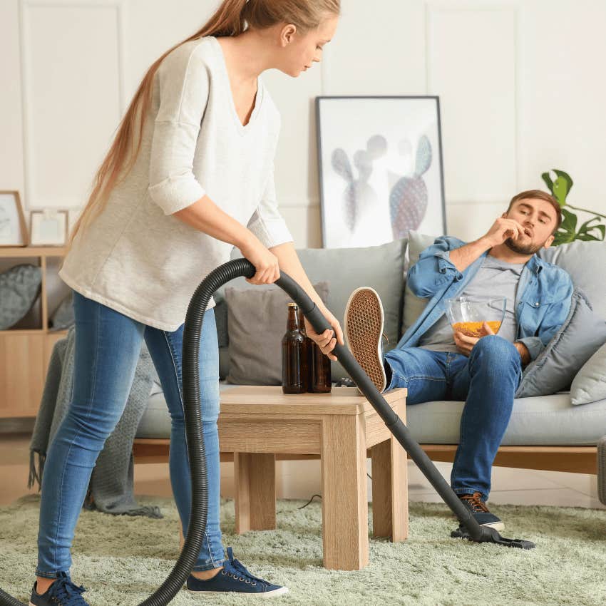 woman doing house chores while relaxes on couch