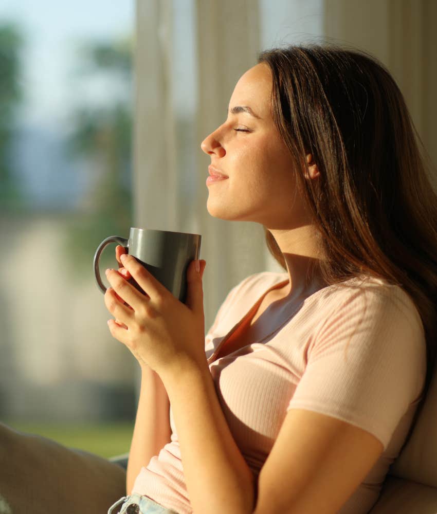 Woman enjoying quiet time alone in the morning with her cup of coffee