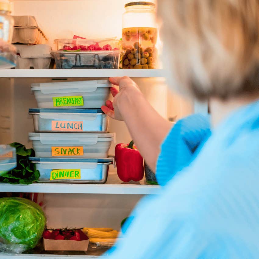 woman reaching for meal prep container