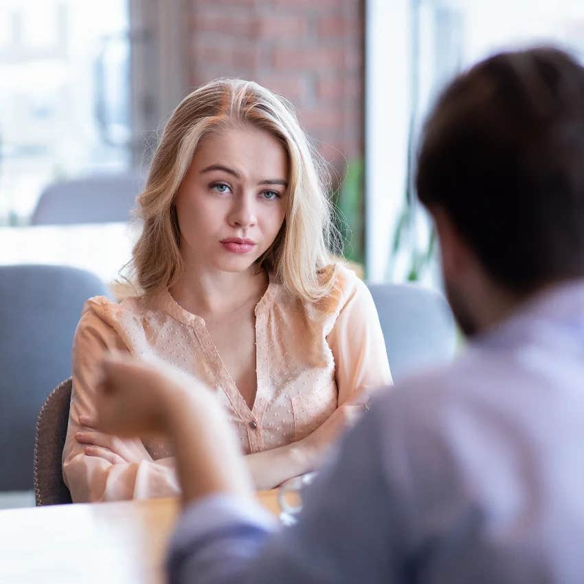 unimpressed woman listening to man say i don't actually believe women feel love
