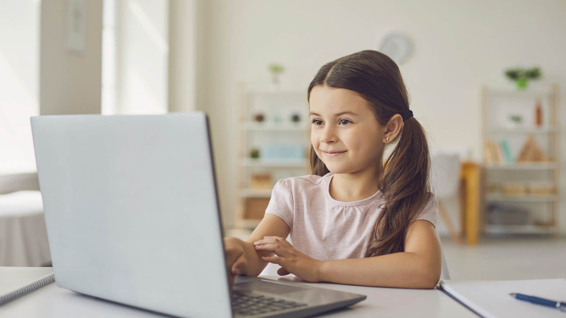 little girl doing online learning