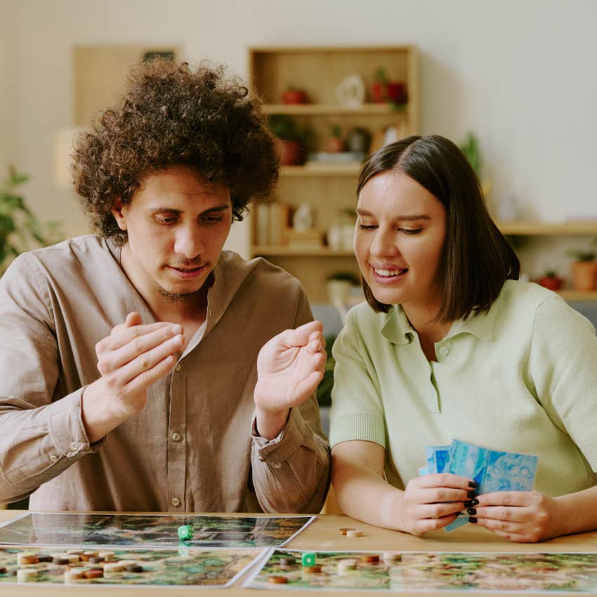 couple playing board game living life at a slower pace