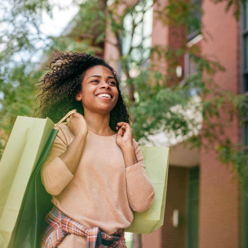 financially irresponsible young woman walking home after a shopping spree