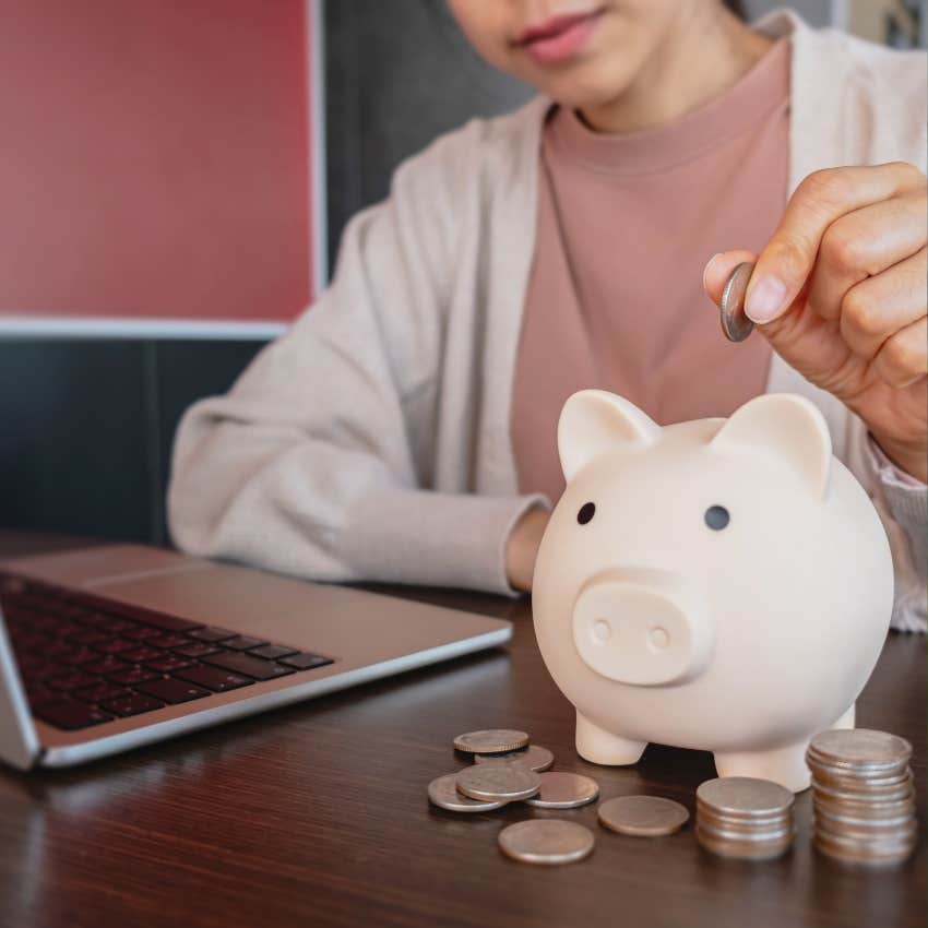 person counting coins in a piggy bank trying to live within their means