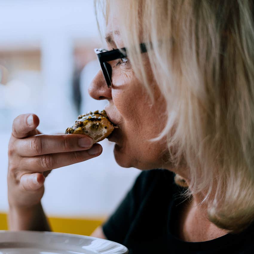 Woman packing up even a couple bites from a restaurant.