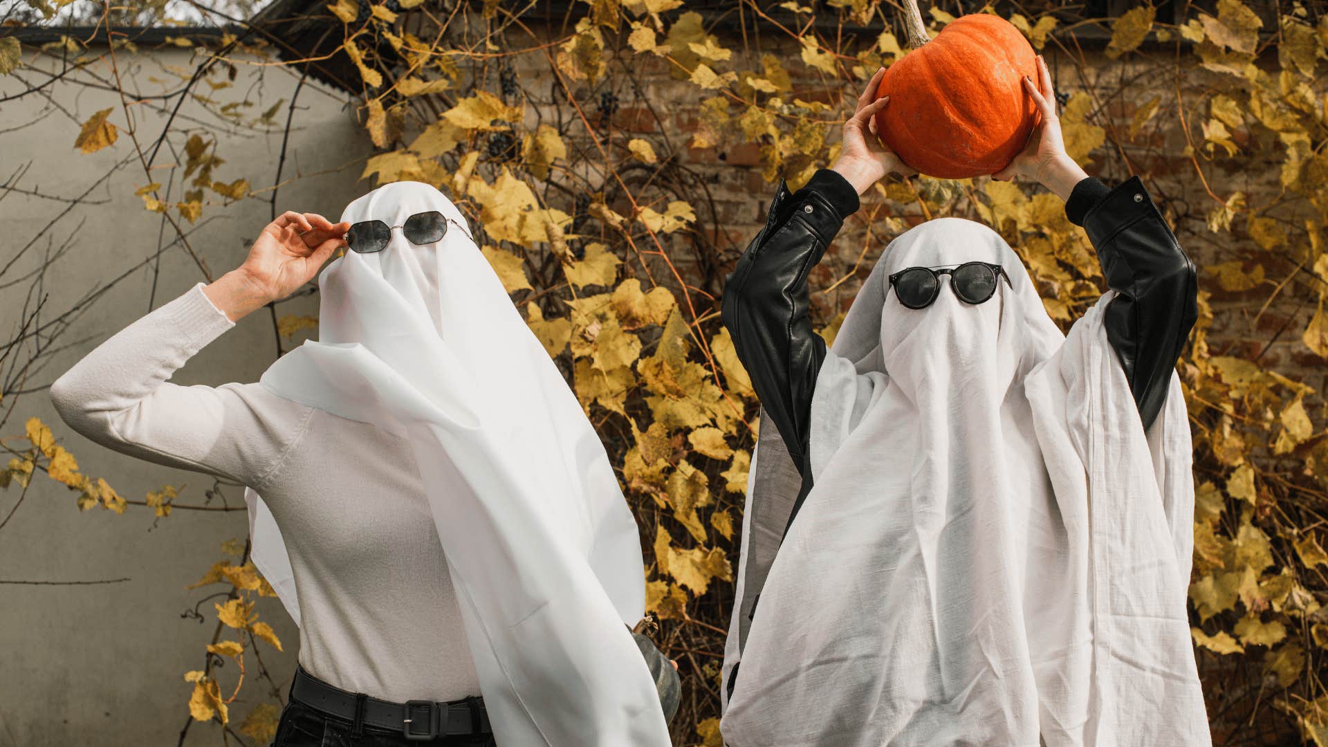 two kids wearing homemade ghost costumes with sunglasses