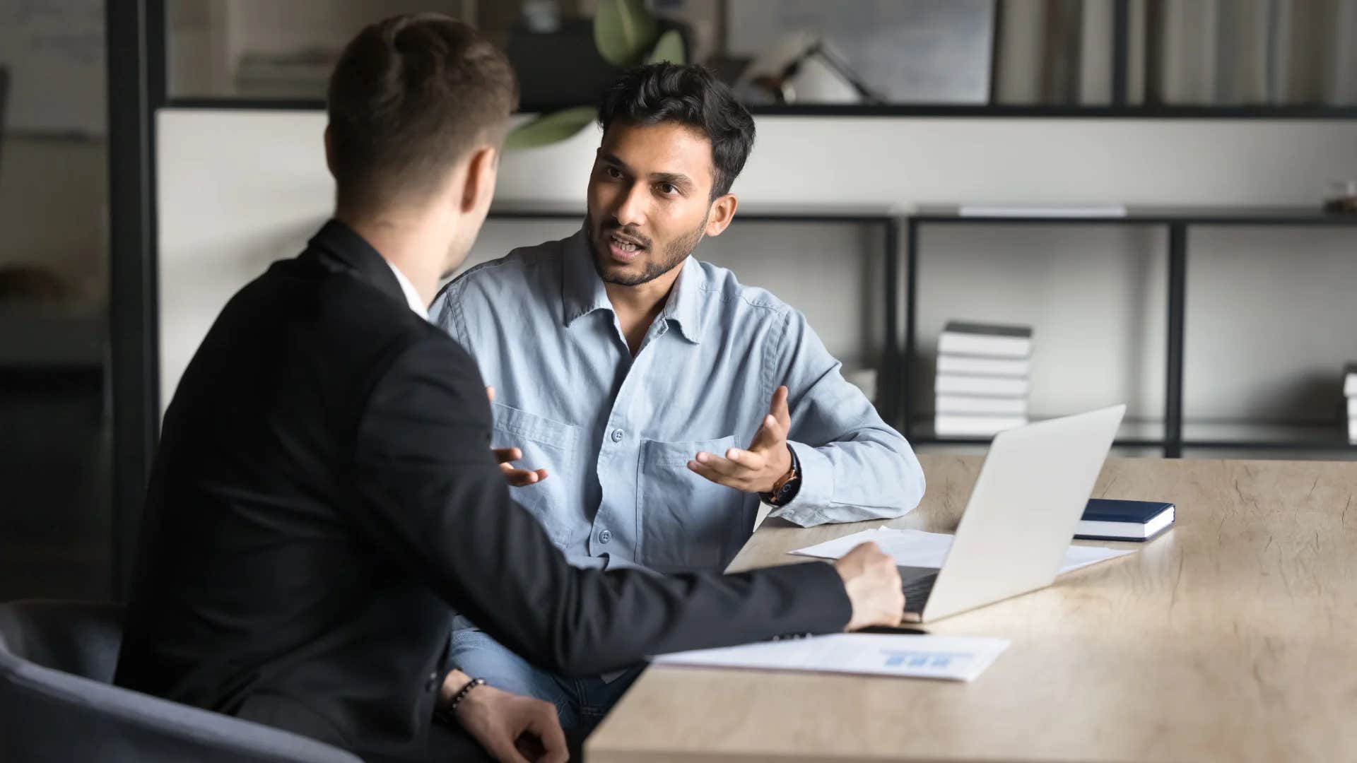 professional man telling colleague let's circle back when we both have a bit more time to discuss