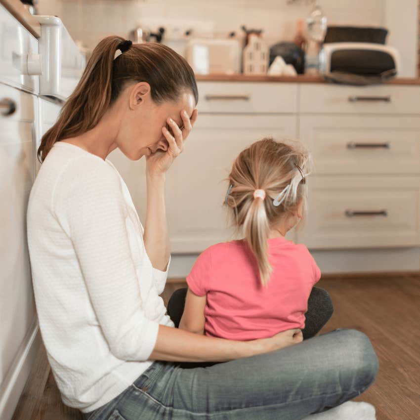 busy woman holding a child not having time for any sadness