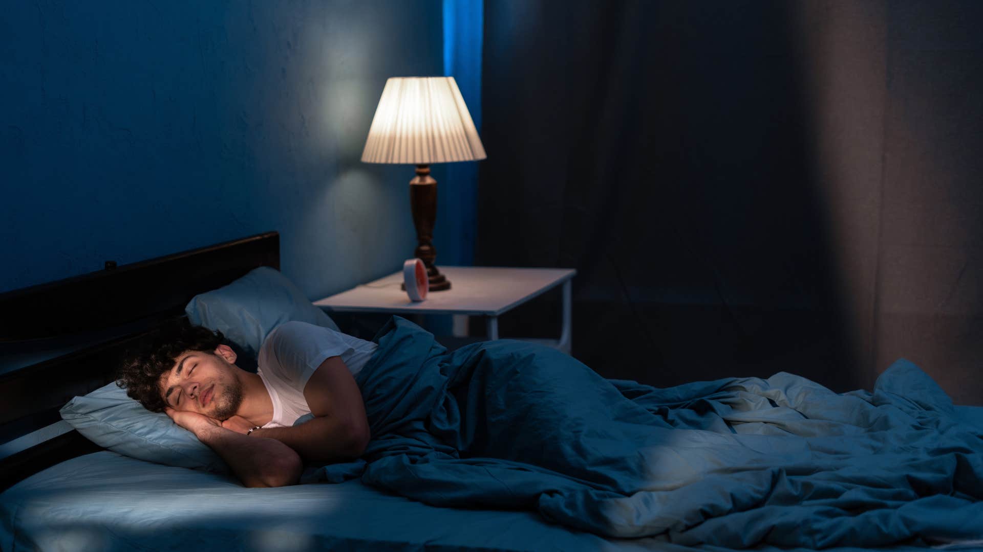 man sleeping with night light as a comfort setting from childhood
