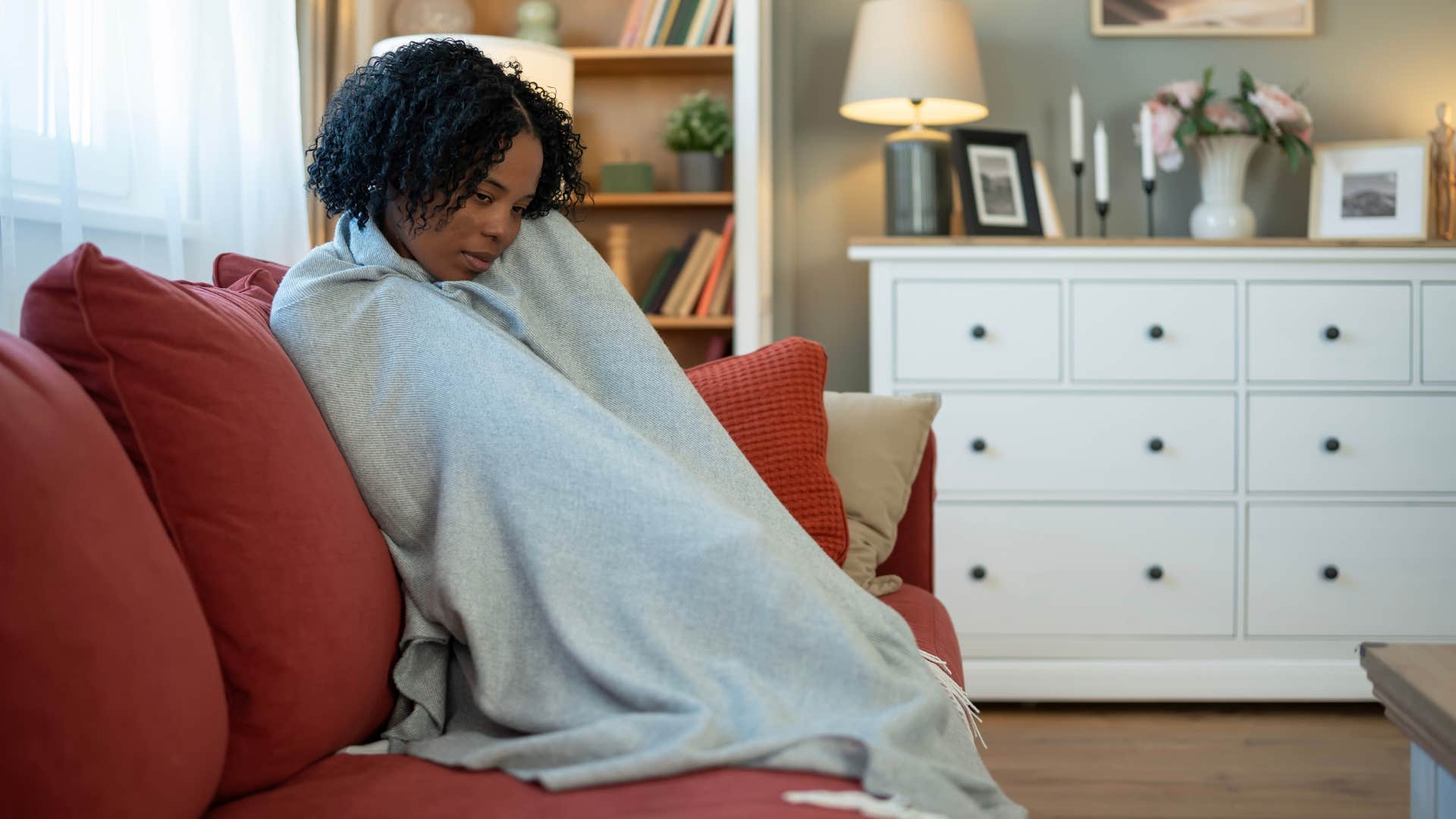 woman snuggling in her favorite blanket as a comfort setting from childhood
