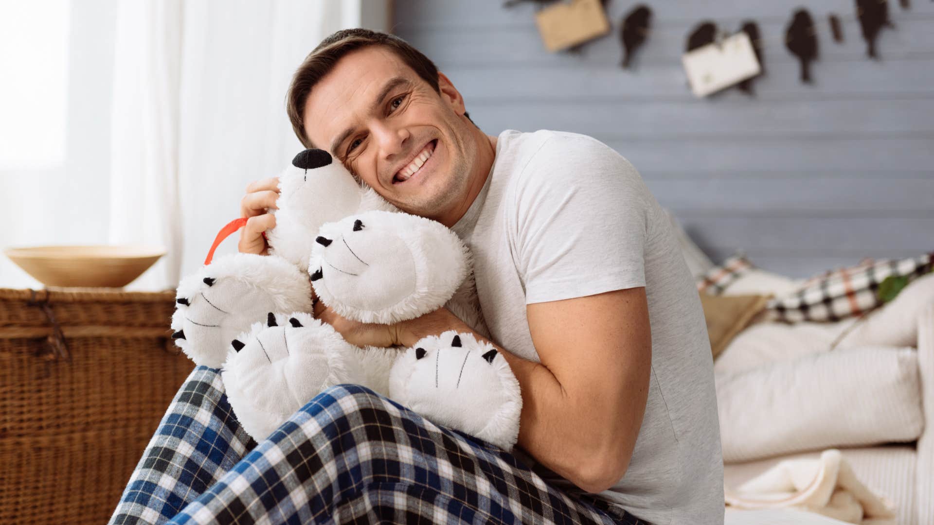 man hugging beloved stuffed animal as a comfort setting from childhood
