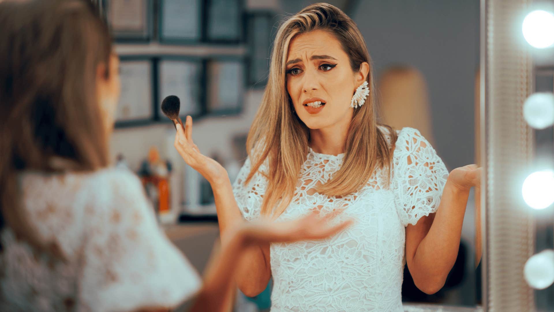 woman in white dress upset as she thinks how much time is reasonable to spend getting ready