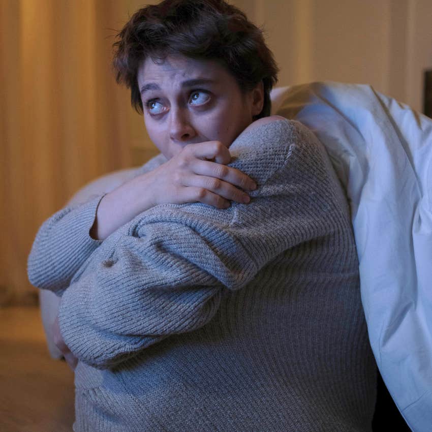 anxious woman feeling nervous hearing muffled voices at home