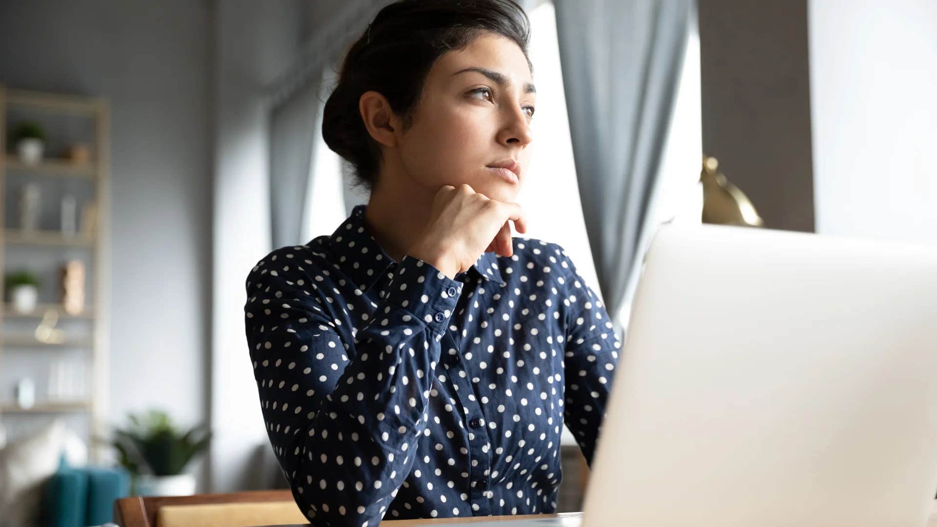pensive millennial woman creating success for herself